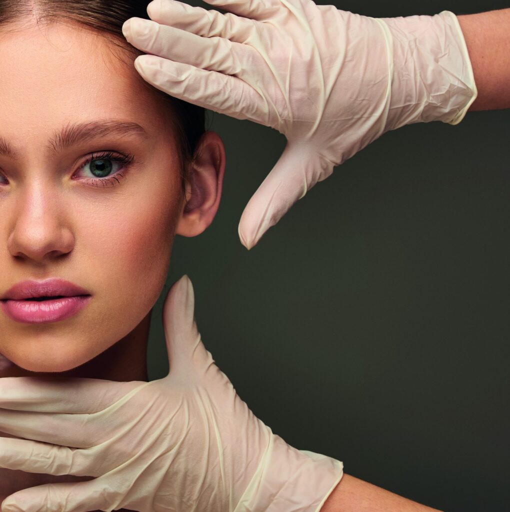 Gloved hands framing a woman's face