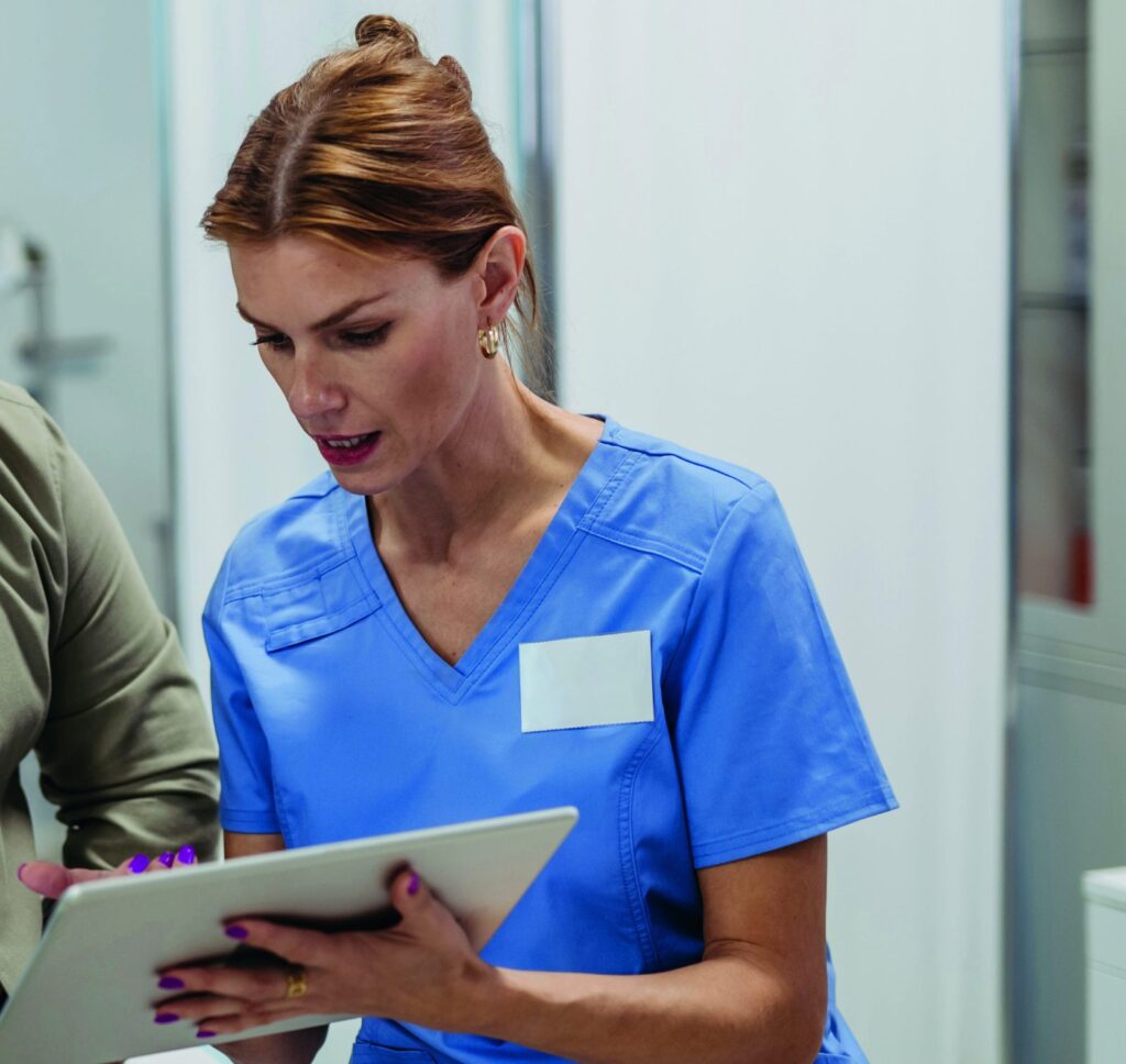Nurse reviewing patient information on a tablet