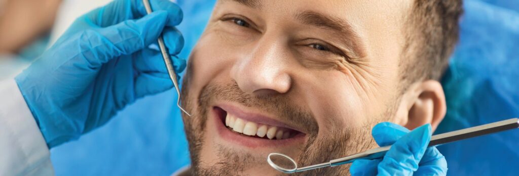 Man with a bright, even smile at the dentist