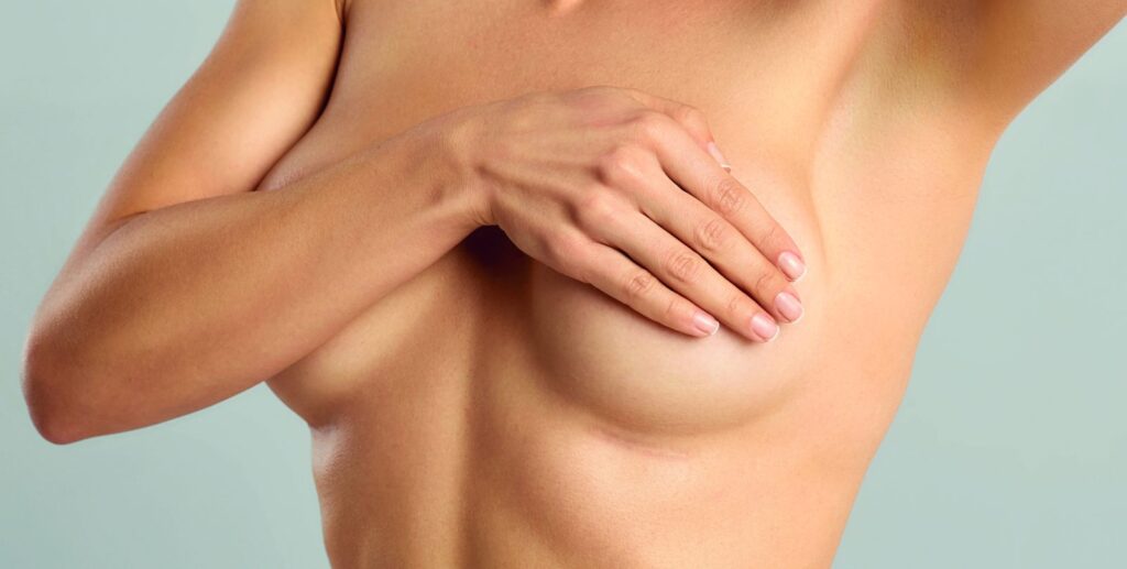 Woman covering her chest, breast surgery theme