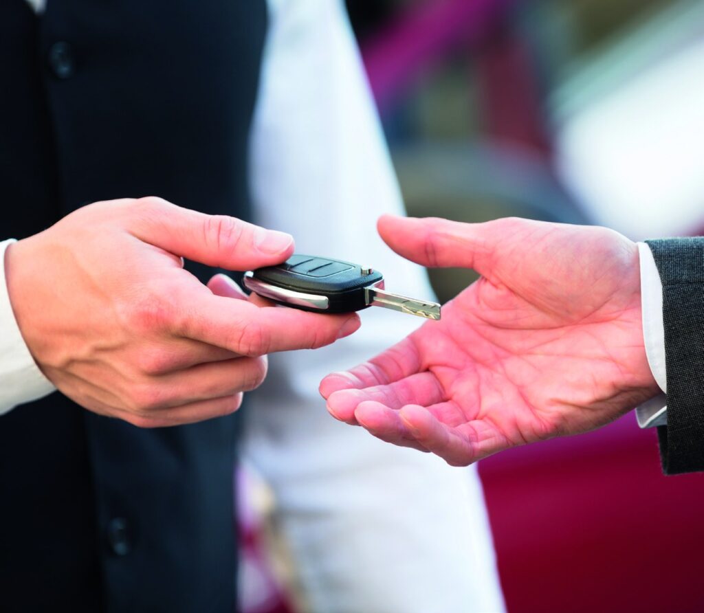 Chauffeur handing over car keys